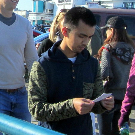 Man reads Gospel tract at Fisherman's Wharf